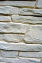 Sandy color plaster on old brick wall, grunge texture vertical Royalty Free Stock Photo