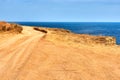 A sandy country road along the edge of the cliff. Royalty Free Stock Photo