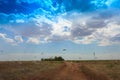 Sandy country road in the salt desert landscape on a hot summer Royalty Free Stock Photo