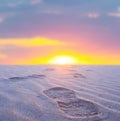 Desert with closeup human track at the sunset