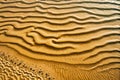 Sandy Dune Waves Texture: Abstract desert pattern with textured sand dunes and rippling waves, Royalty Free Stock Photo