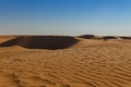 Sandy dunes on the horizon of the Sahara desert of Tunisia Royalty Free Stock Photo