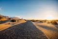 Sandy dunes with road at sunset in Famara beach, Lanzarote Royalty Free Stock Photo