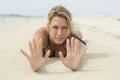 Sandy hands. A beautiful blonde woman lays at the beach. Royalty Free Stock Photo