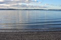 Sandy harbour shore with calm water