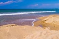 Sandy heap ashore and water inflow closeup