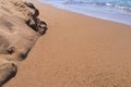 Sandy heap ashore and water inflow closeup