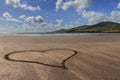 Sandy heart at the coastline
