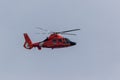 Red Coast Guard Helicopter patrols the area