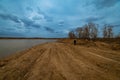 sandy lake shore on a cloudy day