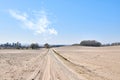 Sandy landscape of a road in the desert sand on a hot summer day with a blue sky background. Dry remote land with a path Royalty Free Stock Photo