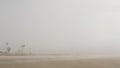 Sandy misty beach California USA. Pacific ocean coast dense fog on sea shore. Milky smog brume haze