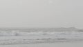 Sandy misty beach California USA. Pacific ocean coast, dense fog on sea shore. Waves in brume haze.