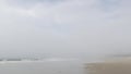 Sandy misty beach California USA. Pacific ocean coast, dense fog on sea shore. Waves in brume haze.