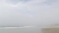Sandy misty beach California USA. Pacific ocean coast, dense fog on sea shore. Waves in brume haze.