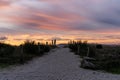 Sandy path and beach access leading through dunes under a colorful sunrise morning sky Royalty Free Stock Photo