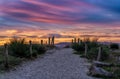 Sandy path and beach access leading through dunes under a colorful sunrise morning sky Royalty Free Stock Photo
