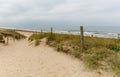 Sandy path leads to an wild beach