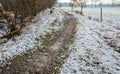 Sandy path in a snowy rural landscape in wintertime Royalty Free Stock Photo