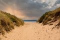 Sandy path to the beach between the dunes Royalty Free Stock Photo