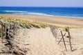 Sandy path way access to the beach sea with wooden fence in summer Royalty Free Stock Photo