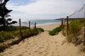 Sandy pathway access french sea coast with sunny atlantic beach sea in summer day Royalty Free Stock Photo