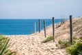 Sandy pathway to the ocean beach. Access path walkway to the sandy beach entrance. Travel tourism vacation