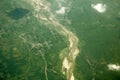 A sandy river bed among villages and green fields, view from a great height. white clouds above the ground. aerial photography Royalty Free Stock Photo