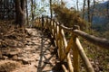 A sandy and rocky road in a tropical Park with a bamboo fence. Royalty Free Stock Photo