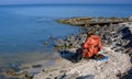 A fisherman in an orange jacket catches fish in the Sea of Azov