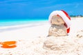 Sandy snowman with red Santa Hat on white Royalty Free Stock Photo