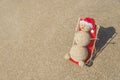 Sandy snowman in santa hat sunbathing in beach lounge. Royalty Free Stock Photo