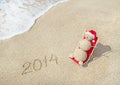 Sandy snowman in santa hat sunbathing in beach lounge. Royalty Free Stock Photo