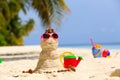 Sandy snowman and toys at sand beach Royalty Free Stock Photo