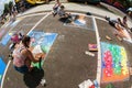 Teenagers Draw Chalk Art On Pavement At Festival Competition Royalty Free Stock Photo