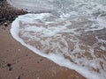 Sandy stone beach sea water close up