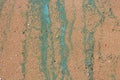 Sandy texture.Background of wet river sand with turquoise stripes of foam.The concept of the environment Royalty Free Stock Photo