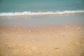 Sandy tropical beach with blur waves at the background Royalty Free Stock Photo