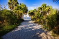 Sandy tropical beach entry or walkway with an ocean view in the background. Royalty Free Stock Photo