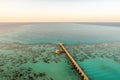 Sanganeb Reef National Park in Sudan, Red Sea, aerial view from Sanganeb Lighthouse with old wooden pier extending towards the sea