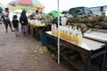 Fruit vendor selling fresh pineapple in street of traditional market.