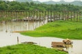 Traditional bamboo floating houses with straw covered roofs at Song Kalia river in Sangkhlaburi, Thailand.