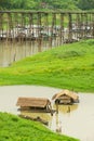 Raditional bamboo floating houses with straw covered roofs at Song Kalia river in Sangkhlaburi, Thailand
