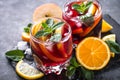 Sangria with fruit, ice and mint in glass.