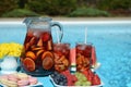 Pool party with sangria and cold alcoholic cocktails by the swimming pool Royalty Free Stock Photo