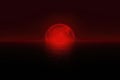 Sanguine Moon - deep blood red moon over the ocean Royalty Free Stock Photo