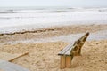 Sanguinet sand wild beach with wood bench empty calm water in landes france