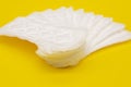 Sanitary napkin or sanitary pad for intimate hygiene on a yellow background Royalty Free Stock Photo