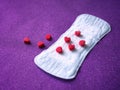 Sanitary napkin and red hearts background Royalty Free Stock Photo