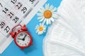 Sanitary napkins, alarm clock and calendar Royalty Free Stock Photo